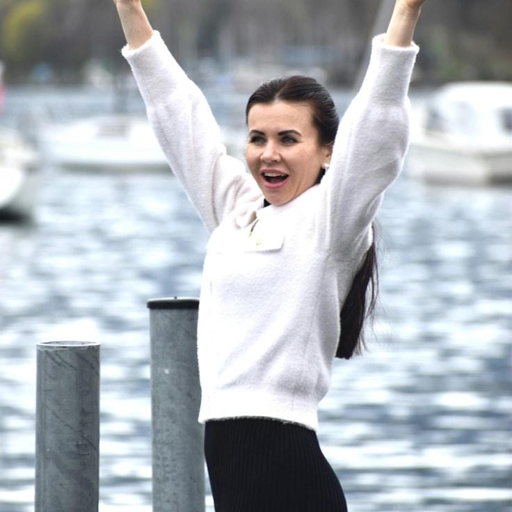 Kaveri Mehta, Lead Design Curator at PebbleIslandHome, reviewing corporate floral arrangements